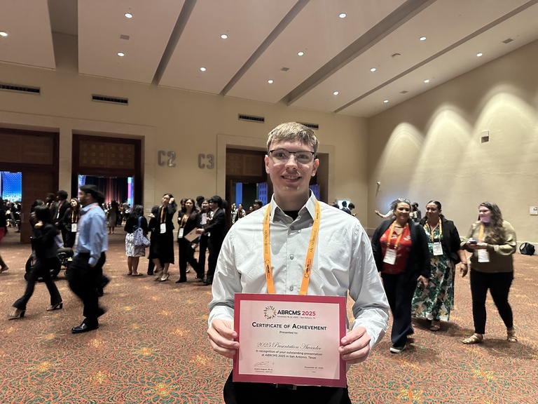 Photo of Jonathan Featherston with his award at the 2025 ABRCMS conference