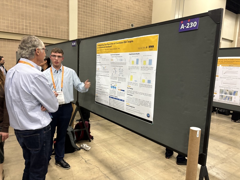 Photo of Jonathan Featherston presenting his poster at the 2025 ABRCMS conference